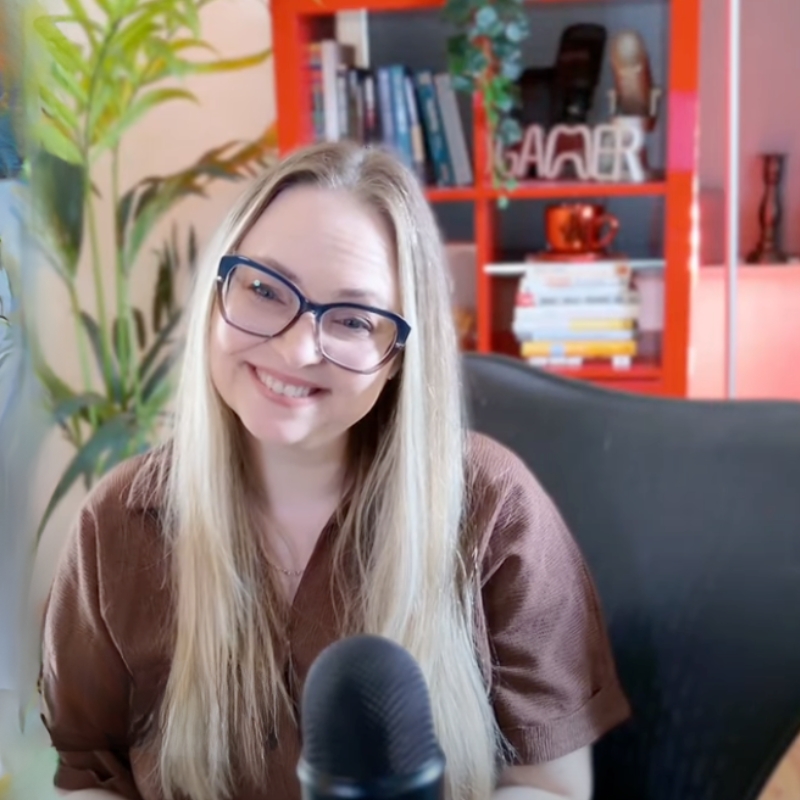 Gina Dunn, brand strategist and host of Morning Cup of Brand Spark, smiling at a podcast microphone in her home studio
